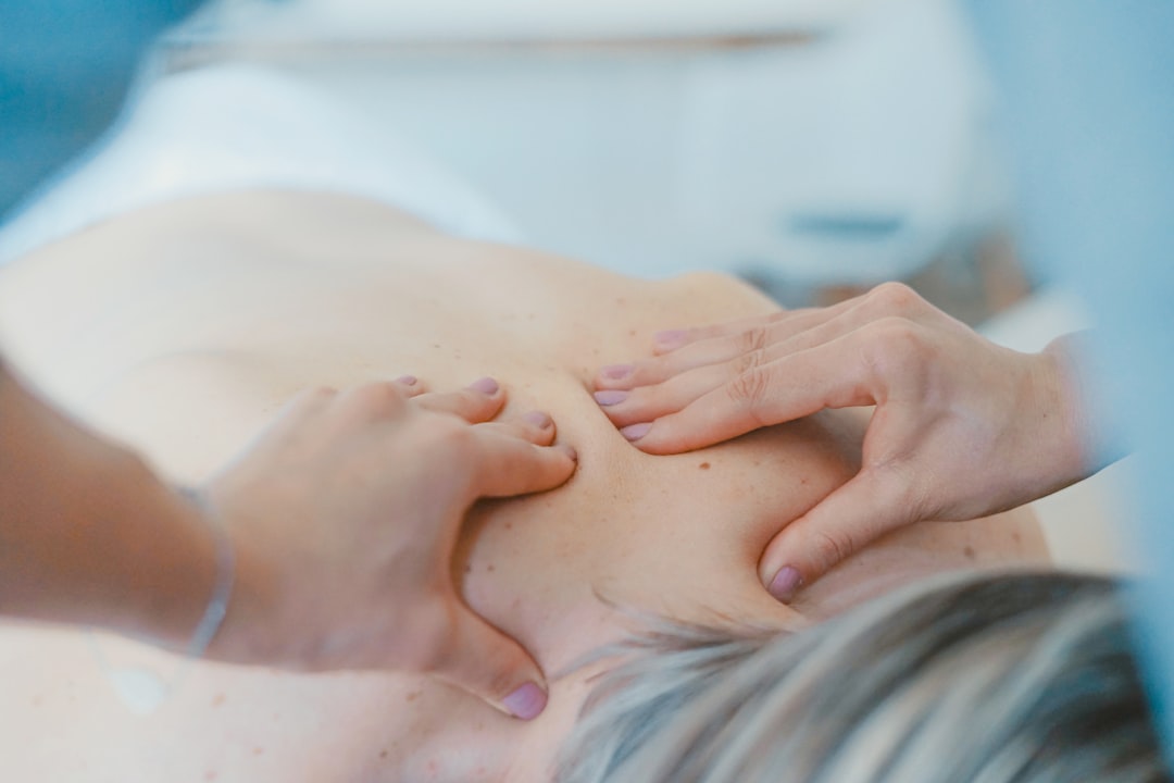 Allied health practitioner treating a patient in a clinic