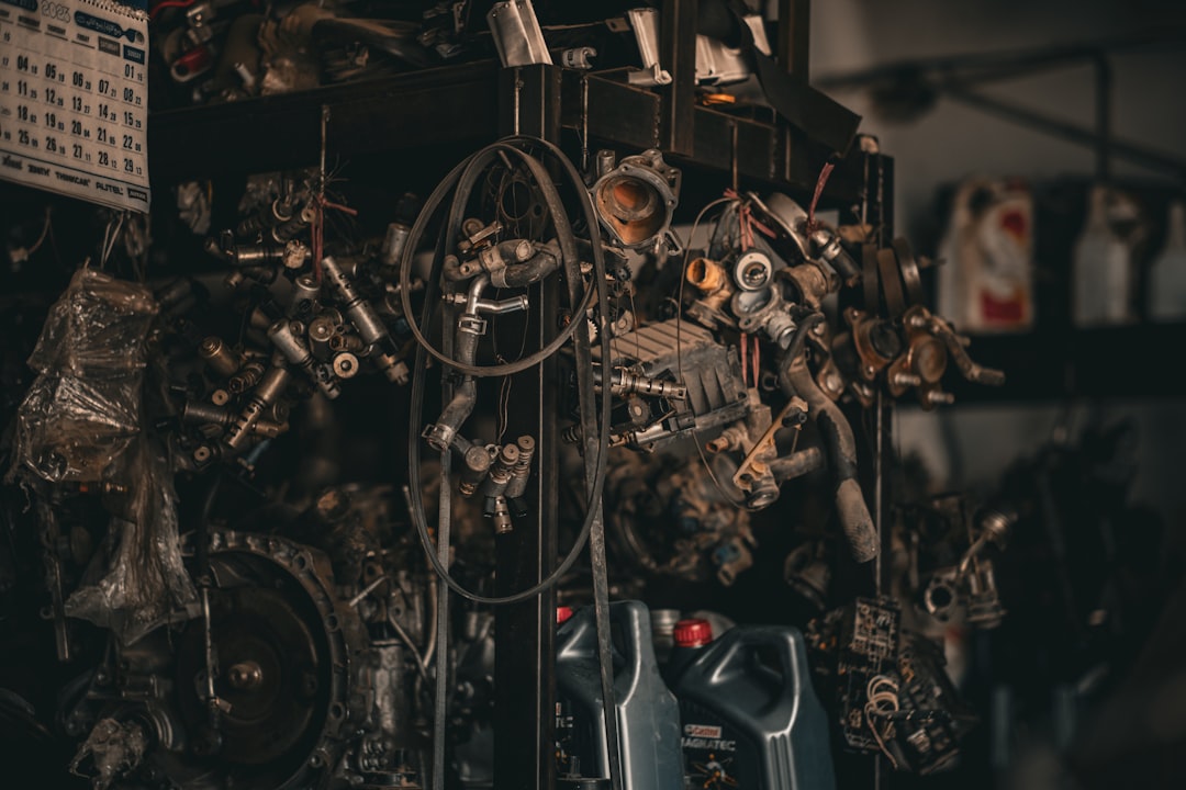 Mechanic working in an auto repair shop service bay, illustrating auto repair shop insurance