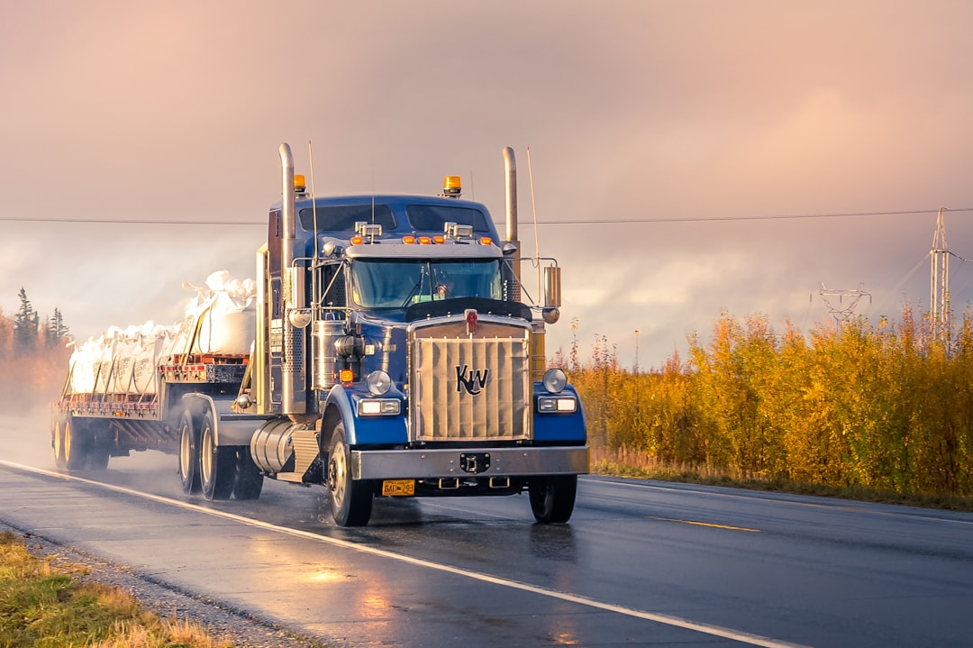 Commercial trucking fleet on interstate highway, illustrating insurance carrier placement and market dynamics