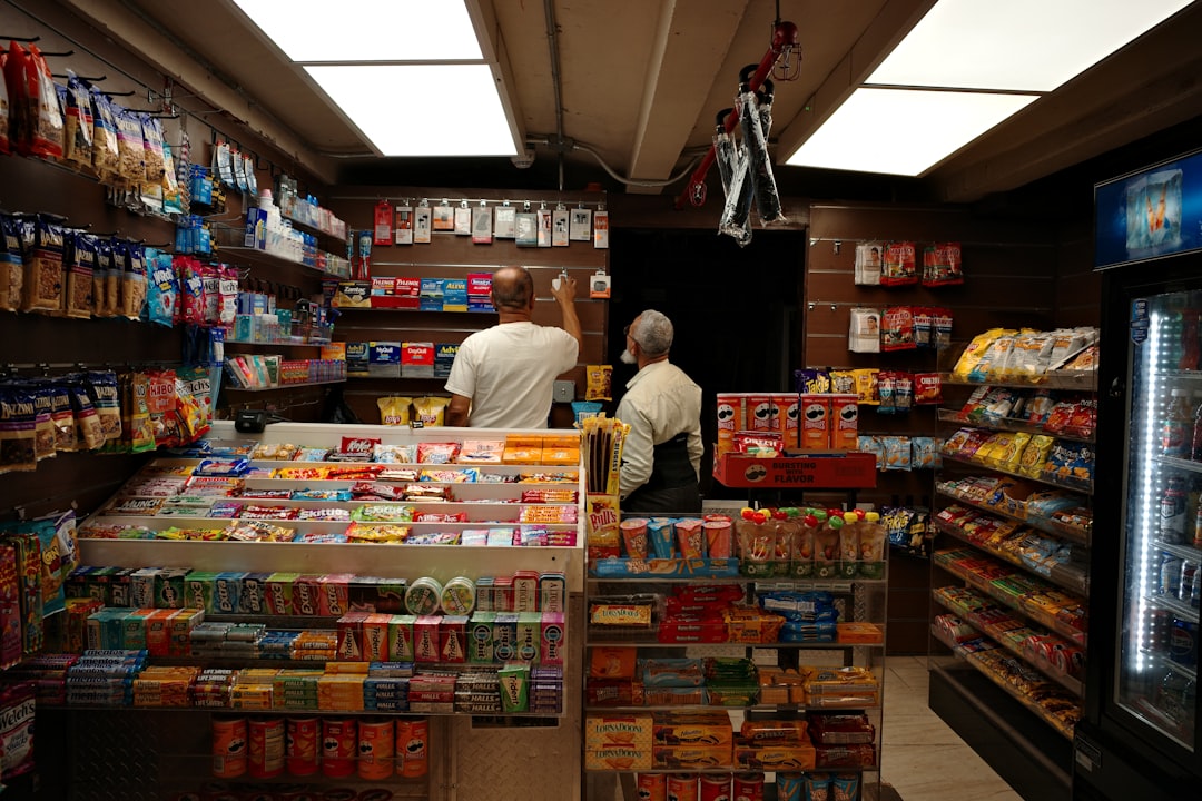 Clerk at a convenience store checkout counter — convenience store insurance FAQ