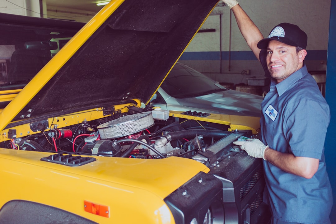 Technician working on an electric vehicle in a repair shop, the core exposure behind EV and hybrid repair shop insurance