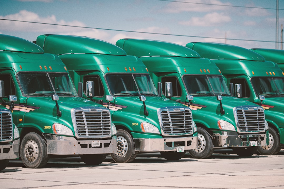 Row of commercial trucks parked at a food distribution facility