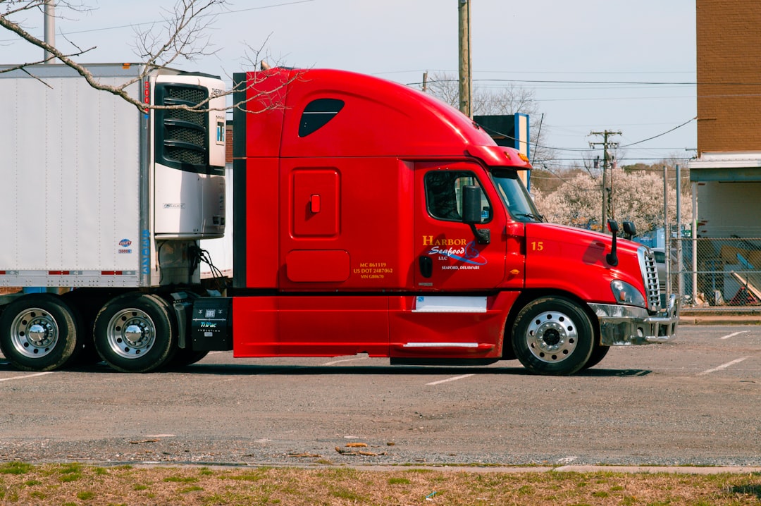 Commercial truck driver inspecting tractor and trailer, illustrating new-authority trucking insurance for first-year for-hire motor carriers