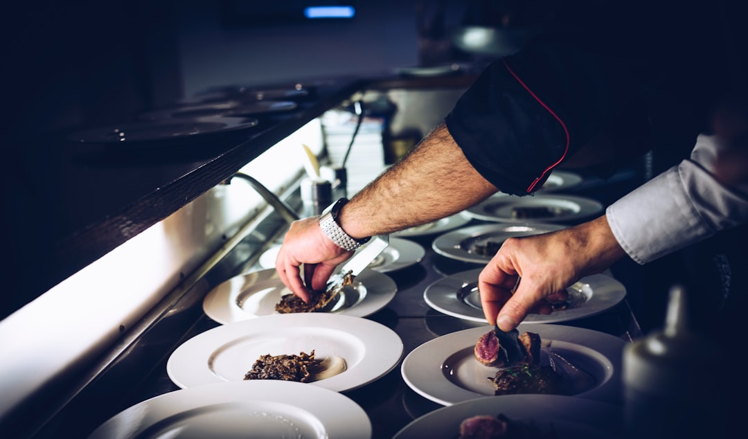 Restaurant kitchen line during dinner service, illustrating the operational profile insurance underwriters evaluate when placing restaurant coverage